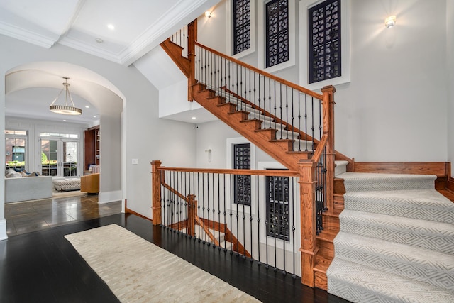 staircase featuring hardwood / wood-style floors and crown molding