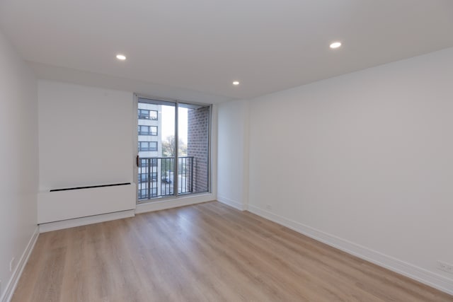 empty room with light hardwood / wood-style floors