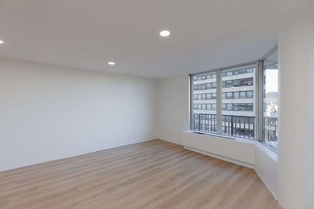 unfurnished room with light wood-type flooring