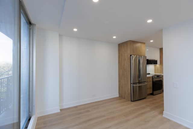 kitchen featuring light hardwood / wood-style floors, white cabinetry, and stainless steel appliances