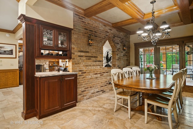 dining room with coffered ceiling, crown molding, beamed ceiling, brick wall, and a chandelier