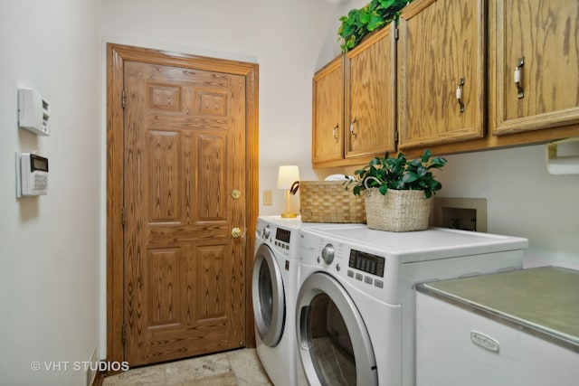 washroom featuring cabinets and washing machine and dryer