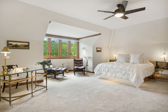 carpeted bedroom with ceiling fan and vaulted ceiling