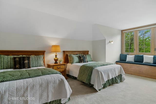 carpeted bedroom featuring lofted ceiling