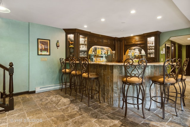 bar with dark brown cabinetry and baseboard heating