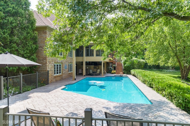 view of pool featuring a patio area and a sunroom