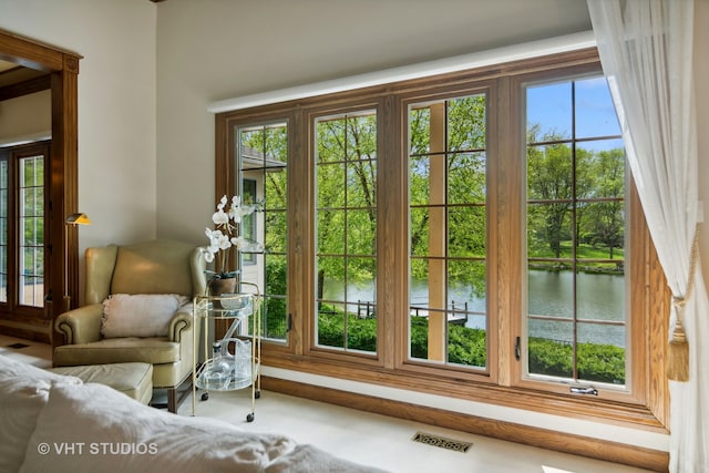 doorway to outside with a water view and plenty of natural light