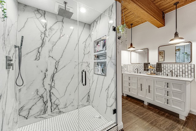 bathroom with beam ceiling, tasteful backsplash, vanity, and walk in shower