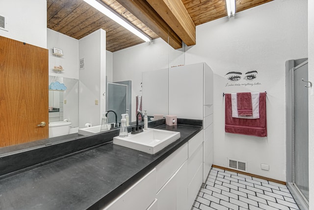 bathroom with beam ceiling, wooden ceiling, tile patterned floors, toilet, and vanity