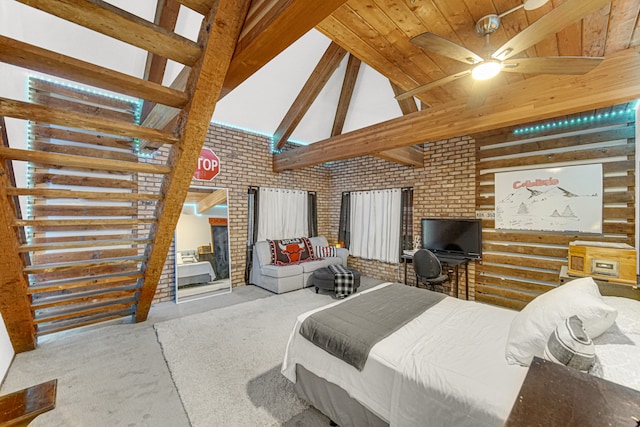 bedroom featuring beamed ceiling, ceiling fan, and brick wall