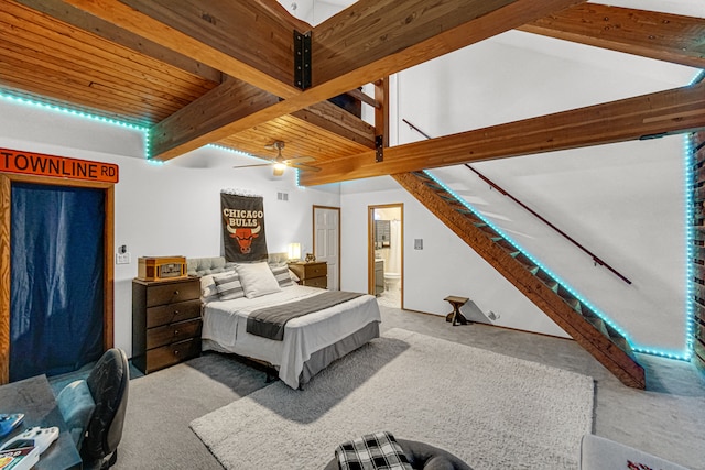 bedroom with ensuite bath, ceiling fan, beamed ceiling, light colored carpet, and wood ceiling