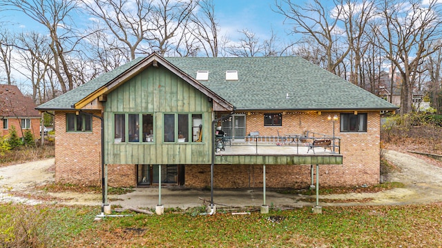 back of house with a patio and a deck