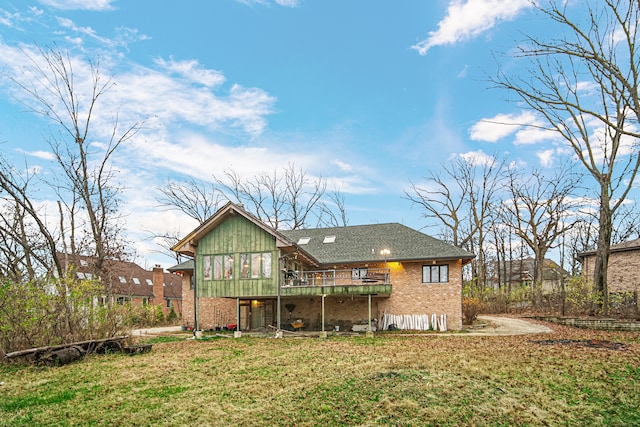 rear view of property with a lawn and a wooden deck