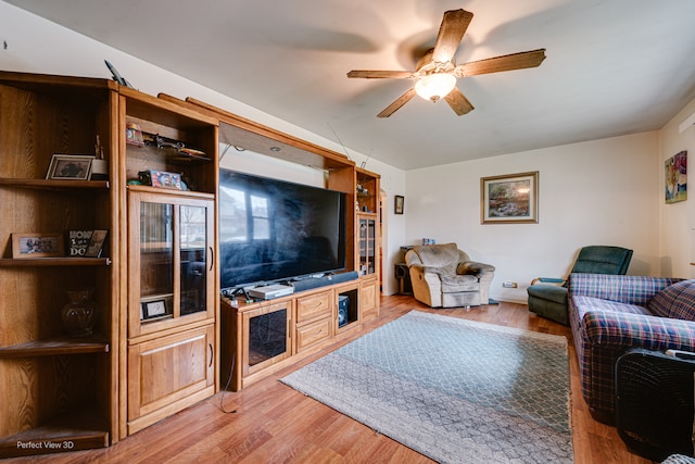 living room with ceiling fan and hardwood / wood-style flooring