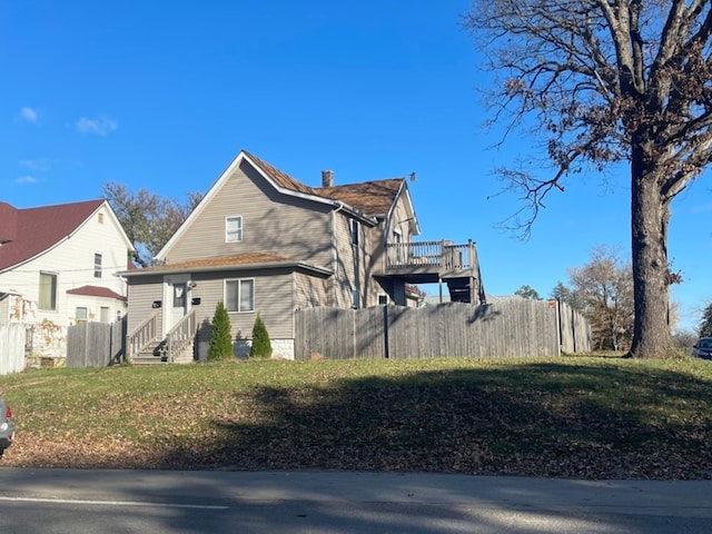 view of side of property with a lawn