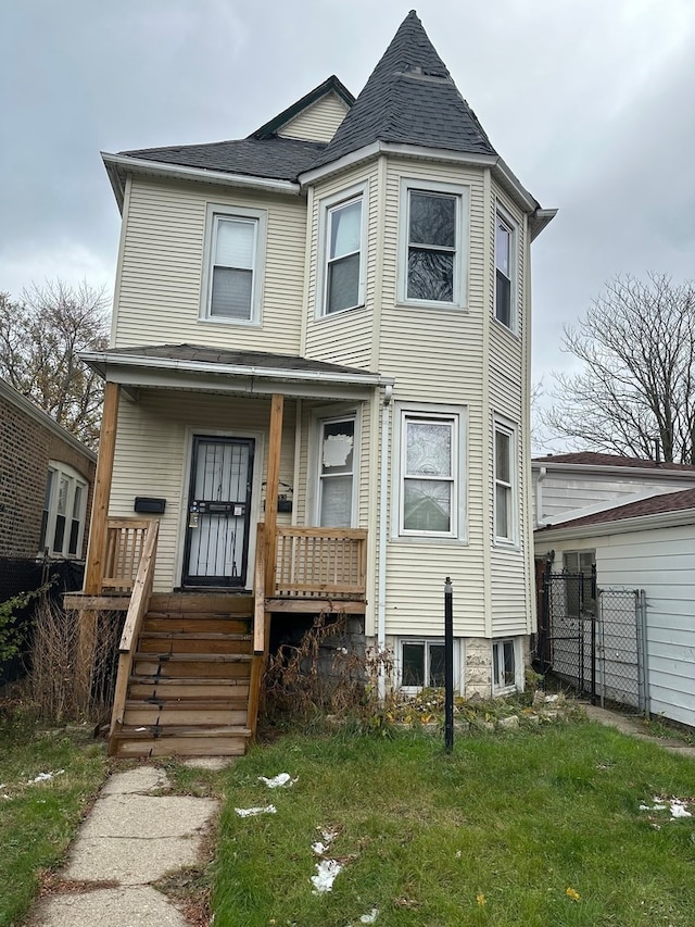 view of front of house with a porch and a front lawn