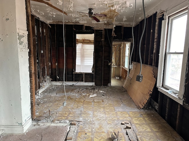 misc room with a wealth of natural light and ceiling fan