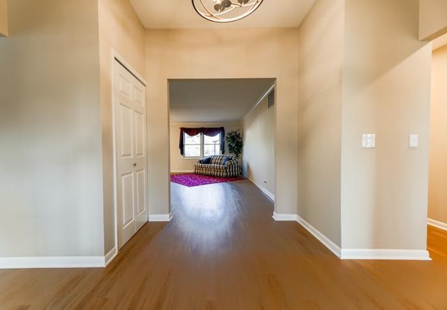 hallway with hardwood / wood-style flooring