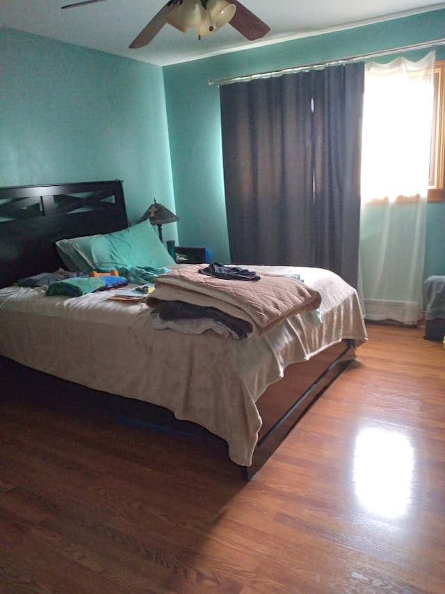 bedroom with hardwood / wood-style flooring and ceiling fan