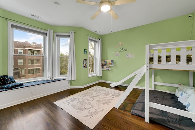 bedroom with dark hardwood / wood-style flooring, multiple windows, and ceiling fan