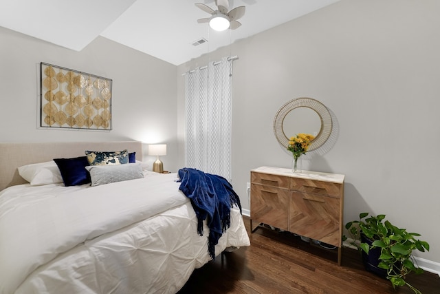 bedroom with dark hardwood / wood-style floors and ceiling fan