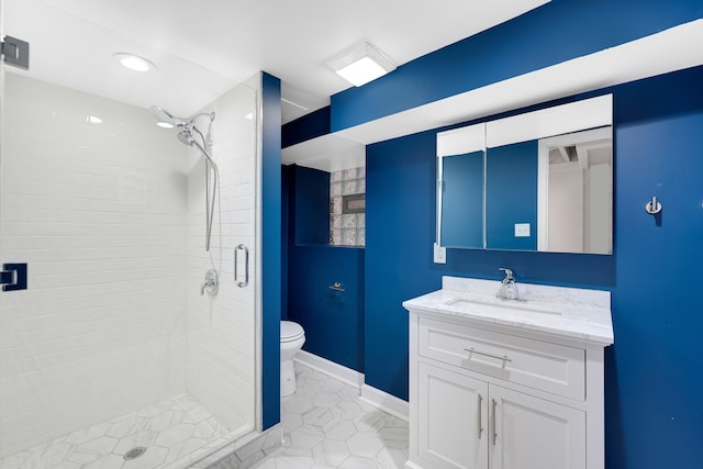 bathroom featuring tile patterned flooring, vanity, toilet, and walk in shower