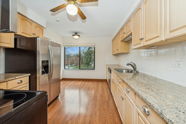 kitchen featuring light stone countertops, ceiling fan, sink, light hardwood / wood-style flooring, and light brown cabinetry