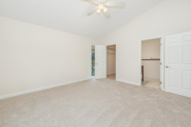 unfurnished bedroom with a walk in closet, light colored carpet, ceiling fan, connected bathroom, and a closet