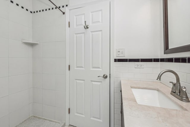 bathroom with vanity and tile walls