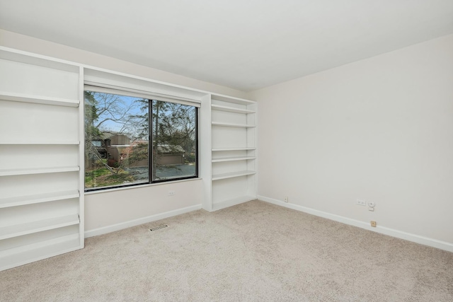 unfurnished room featuring light colored carpet