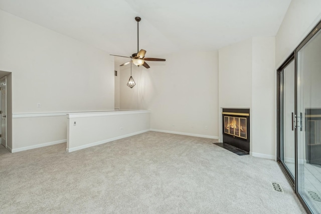 unfurnished living room featuring ceiling fan and light carpet