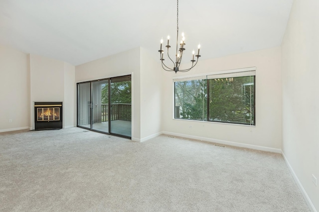 unfurnished living room featuring light colored carpet and a notable chandelier