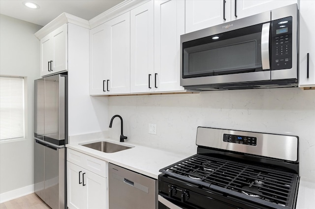 kitchen featuring white cabinets, light hardwood / wood-style floors, sink, and stainless steel appliances