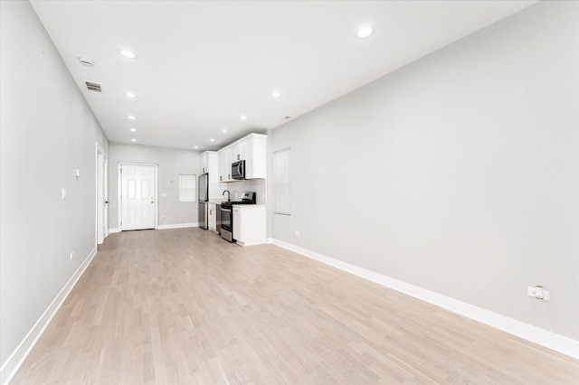 unfurnished living room featuring light hardwood / wood-style floors