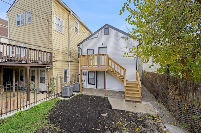 rear view of house featuring a patio, central AC unit, and a wooden deck