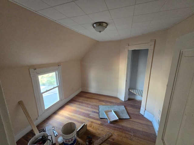 bonus room with hardwood / wood-style flooring and vaulted ceiling