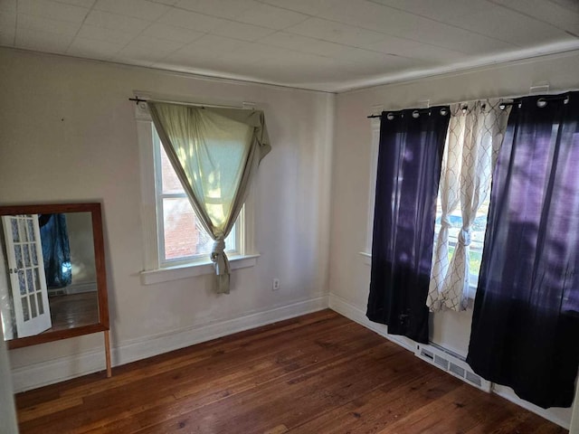 unfurnished room with wood-type flooring