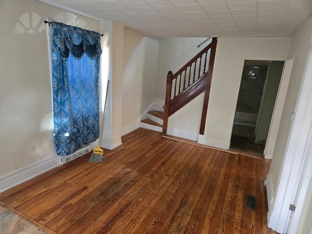 foyer with wood-type flooring and a drop ceiling