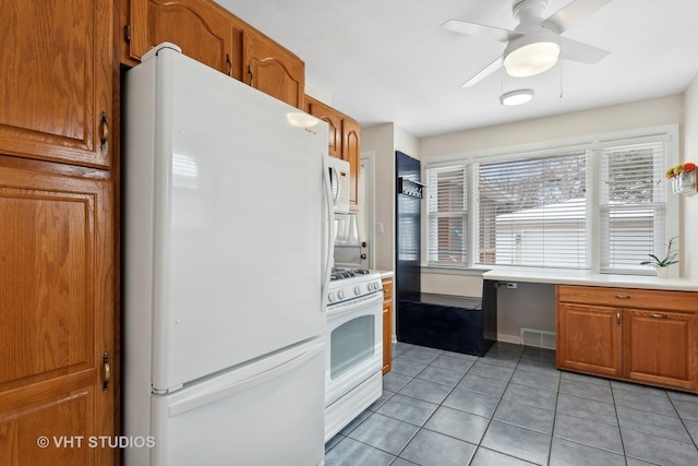 kitchen with ceiling fan, plenty of natural light, light tile patterned flooring, and white appliances