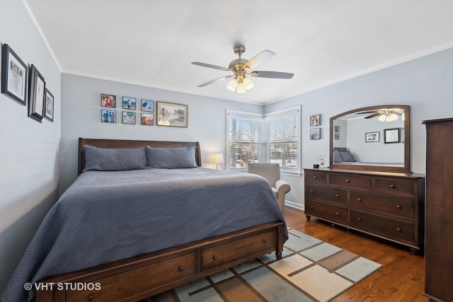 bedroom featuring ceiling fan, dark hardwood / wood-style floors, and ornamental molding