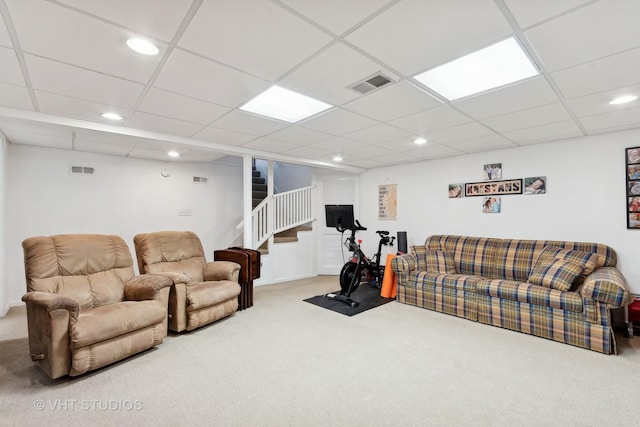 carpeted living room featuring a paneled ceiling