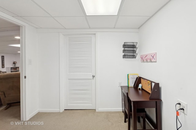 home office with light colored carpet and a drop ceiling