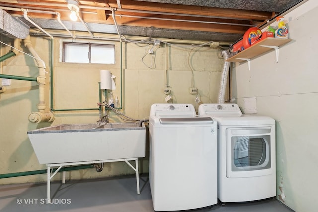 washroom featuring washer and dryer and sink