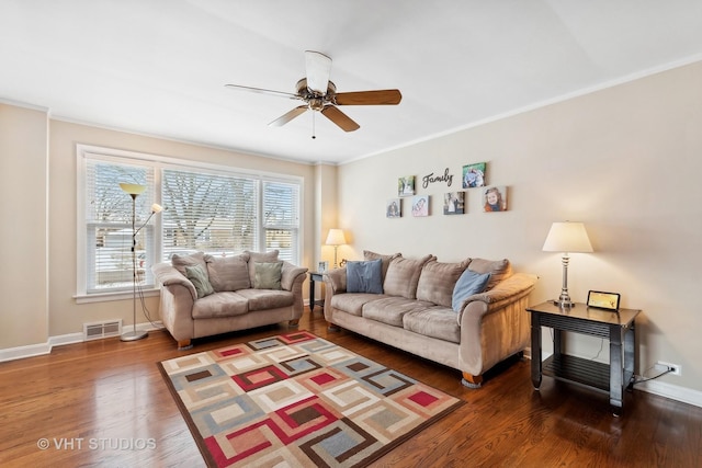 living room with ceiling fan, dark hardwood / wood-style flooring, and ornamental molding