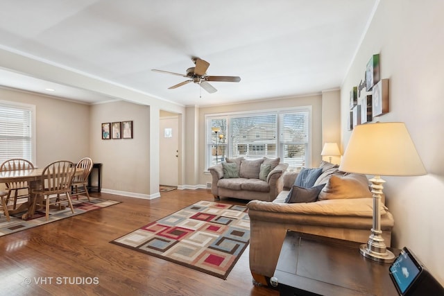 living room with ceiling fan, crown molding, and wood-type flooring