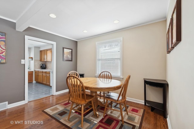 dining space featuring crown molding and light hardwood / wood-style floors