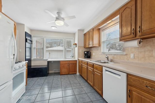 kitchen featuring white appliances, decorative backsplash, sink, ceiling fan, and light tile patterned floors