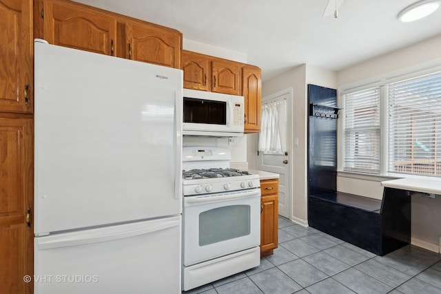 kitchen featuring white appliances and light tile patterned floors