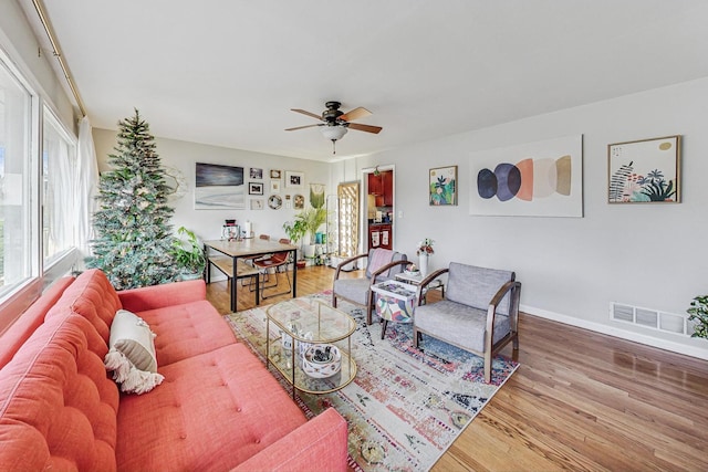 living room featuring hardwood / wood-style flooring and ceiling fan