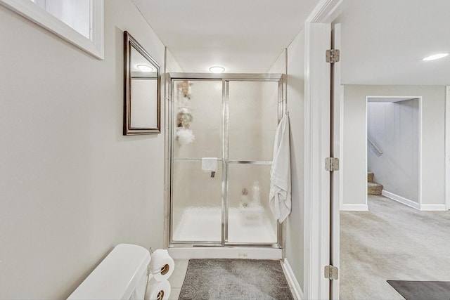 bathroom with toilet and an enclosed shower